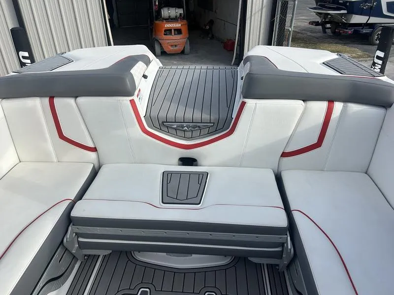 Slide: The Image of 2019 Nautique Super Air G23 boat interior with white and gray seating, red accents. - 5