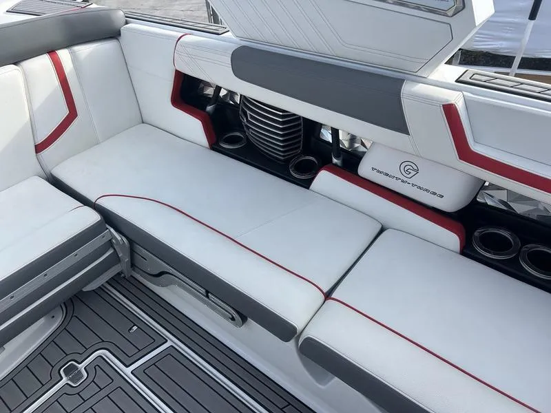 Slide: The Image of 2019 Nautique Super Air G23 interior with white and red seating, cup holders, and sleek design. - 8