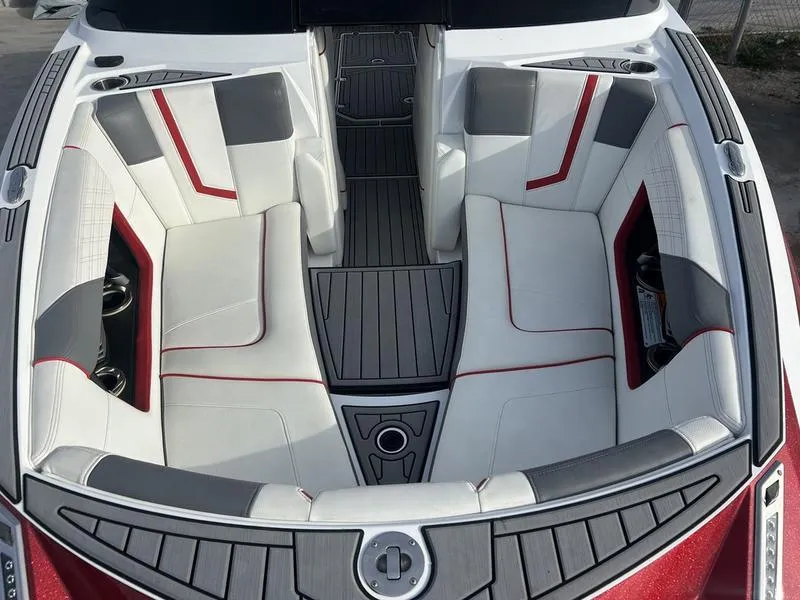 Slide: The Image of 2019 Nautique Super Air G23 boat interior with gray and red seating. - 9