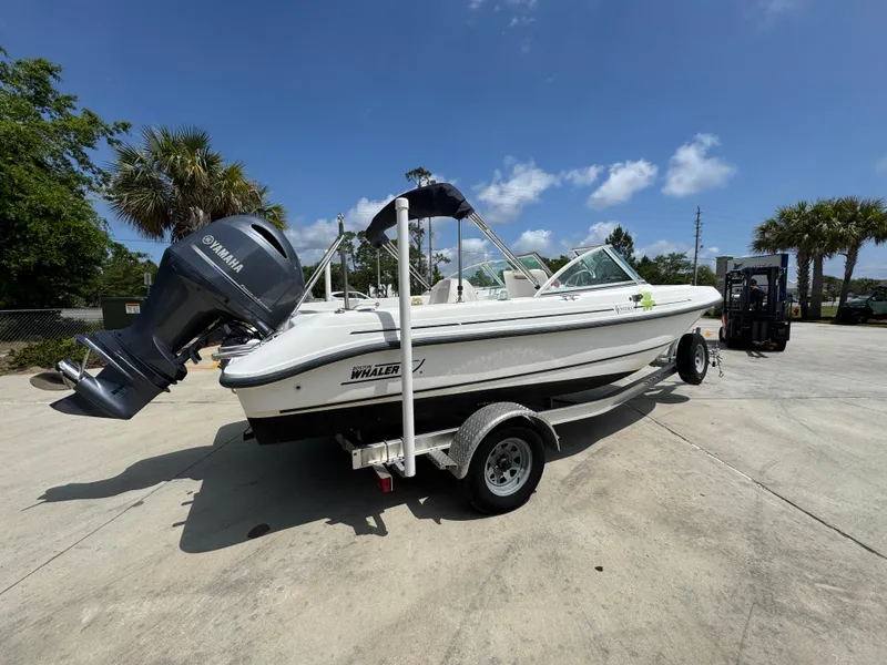 Slide: The Image of 2001 Boston Whaler 18 Ventura boat on trailer, Yamaha outboard, sunny day, palm trees in background. - 11
