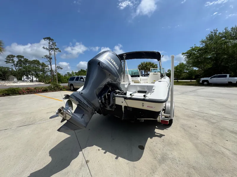 Slide: The Image of 2001 Boston Whaler 18 Ventura boat with Yamaha outboard motor in a sunny parking lot. - 13