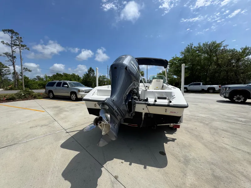 Slide: The Image of 2001 Boston Whaler 18 Ventura boat with outboard motor in a parking lot. - 14