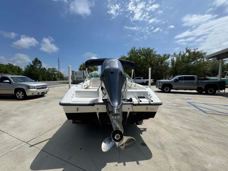 Slide: The Image of 2001 Boston Whaler 18 Ventura boat with outboard motor in a parking lot. - 15