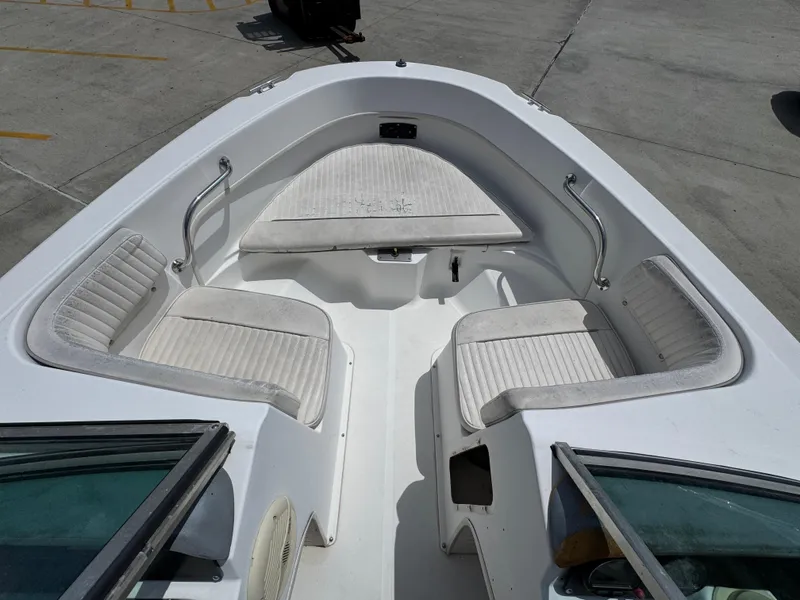 Slide: The Image of 2001 Boston Whaler 18 Ventura boat interior with white seating and storage compartments. - 16
