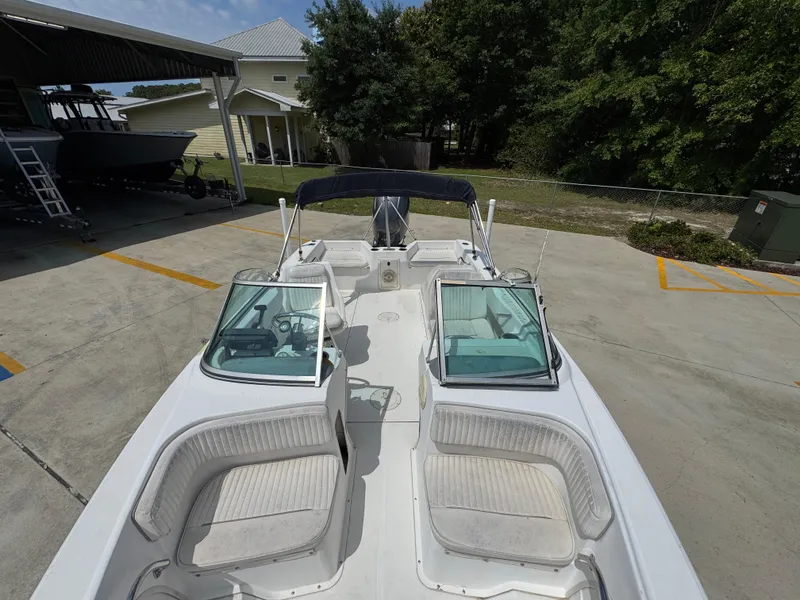 Slide: The Image of 2001 Boston Whaler 18 Ventura boat with dual windshields and seating, parked outdoors. - 18