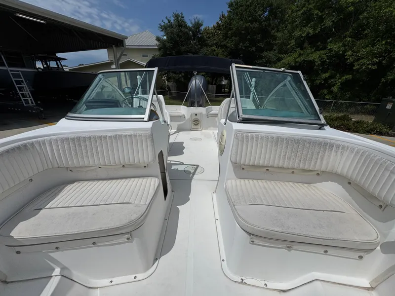 Slide: The Image of 2001 Boston Whaler 18 Ventura boat interior with cushioned seating and open deck. - 19