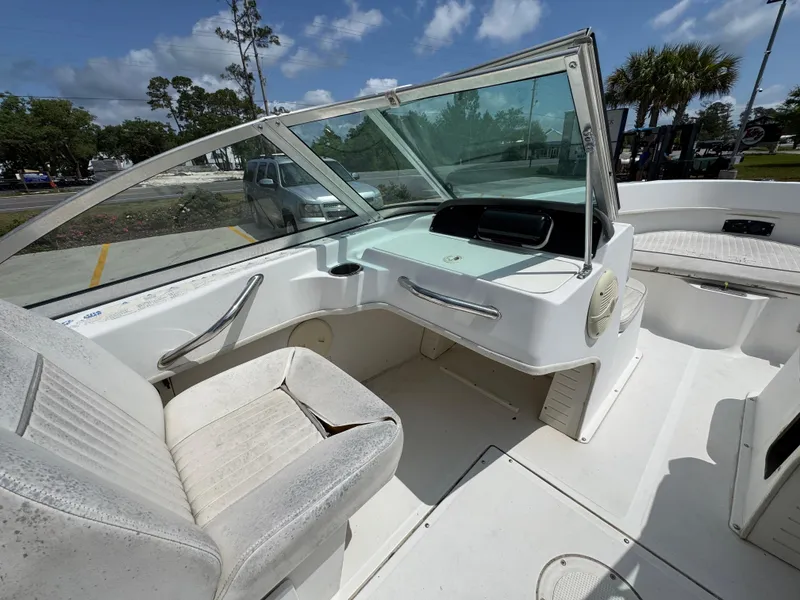 Slide: The Image of 2001 Boston Whaler 18 Ventura boat interior with seating and windshield under blue sky. - 23