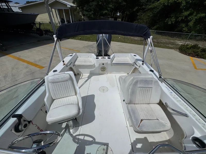 Slide: The Image of 2001 Boston Whaler 18 Ventura boat interior with seating and steering wheel. - 24