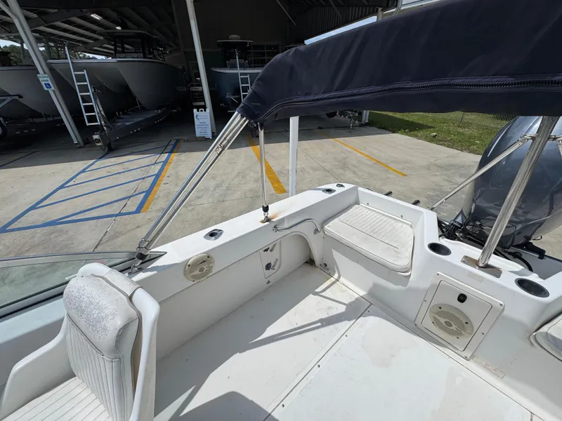 Slide: The Image of 2001 Boston Whaler 18 Ventura boat interior with seating and canopy in a storage area. - 26