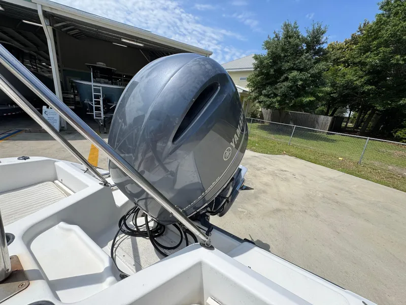 Slide: The Image of 2001 Boston Whaler 18 Ventura with Yamaha outboard motor, parked outdoors. - 29