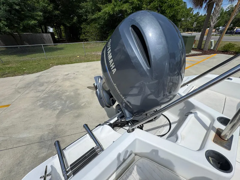Slide: The Image of 2001 Boston Whaler 18 Ventura with Yamaha outboard motor, docked outdoors. - 30
