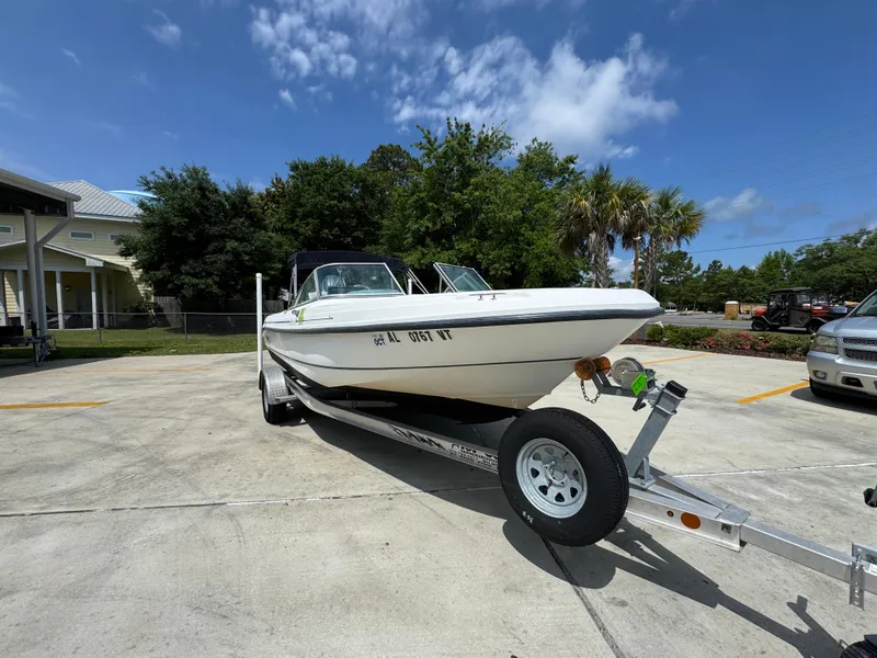 Slide: The Image of 2001 Boston Whaler 18 Ventura boat on trailer in sunny parking lot. - 7