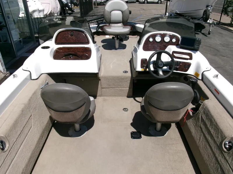Slide: The Image of 2005 Tracker Tundra 18 DC boat interior with dual consoles and seating. - 10