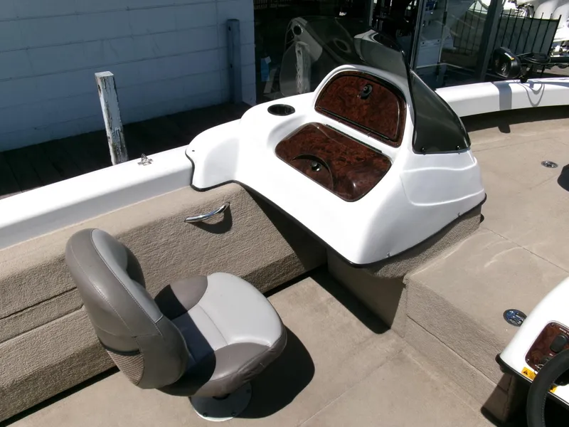 Slide: The Image of 2005 Tracker Tundra 18 DC boat interior with gray seat and dashboard. - 13