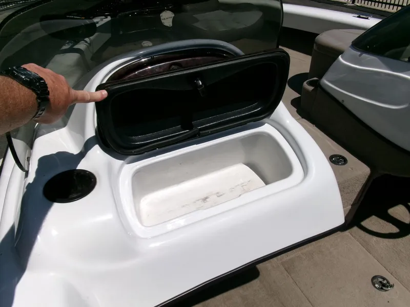 Slide: The Image of 2005 Tracker Tundra 18 DC boat storage compartment open, showing interior space. - 14