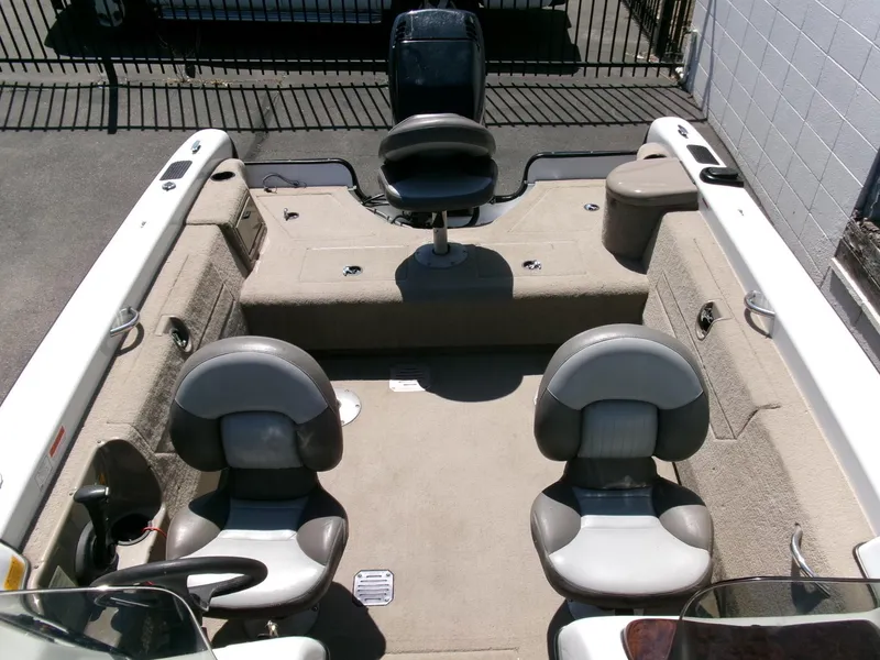 Slide: The Image of 2005 Tracker Tundra 18 DC boat interior with three seats and carpeted flooring. - 19