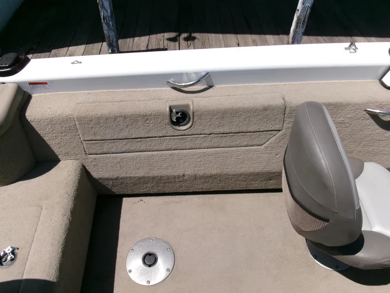 Slide: The Image of 2005 Tracker Tundra 18 DC boat interior with seating and storage compartment. - 20