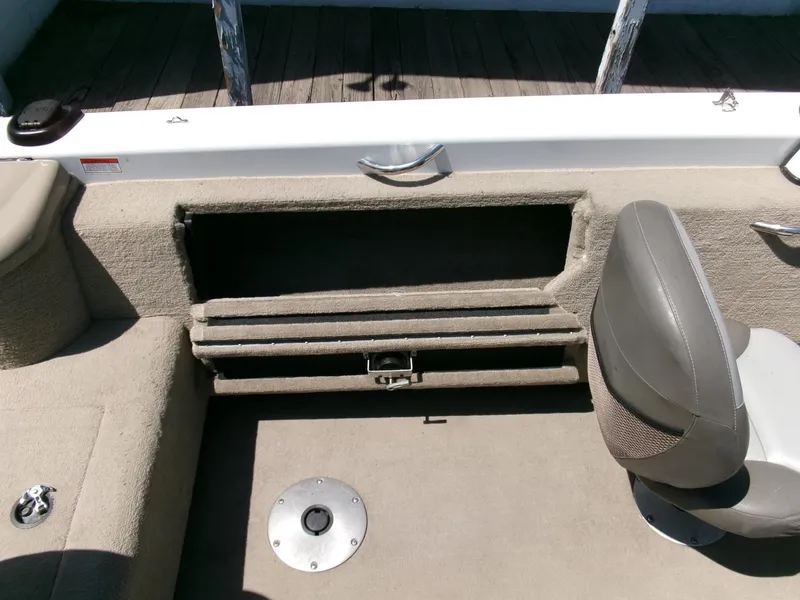 Slide: The Image of 2005 Tracker Tundra 18 DC boat interior with storage compartment and seating. - 21