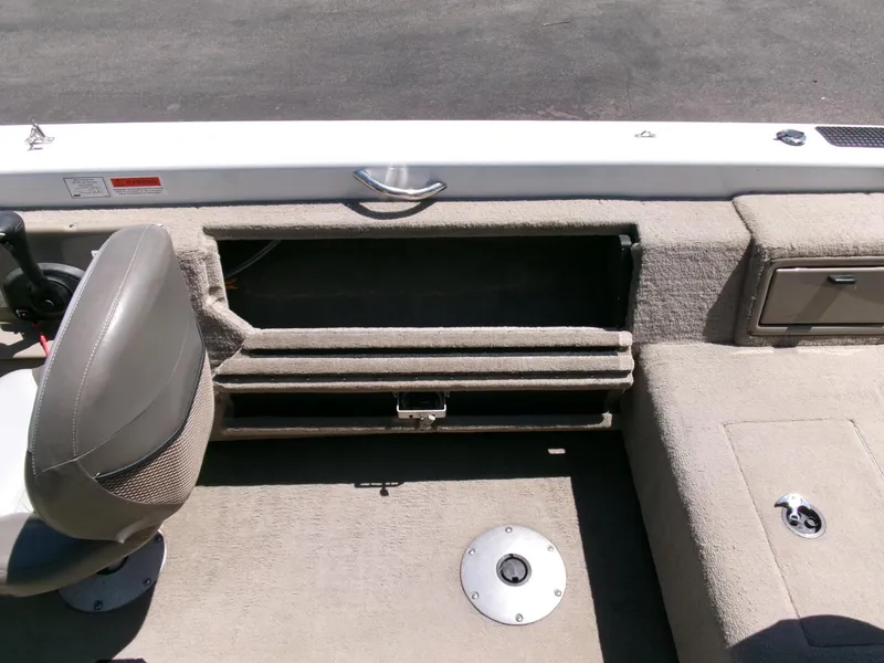 Slide: The Image of 2005 Tracker Tundra 18 DC boat interior with storage compartment and seating. - 22