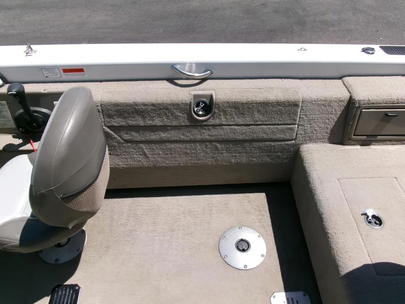 Slide: The Image of 2005 Tracker Tundra 18 DC boat interior with seating and storage compartments. - 23