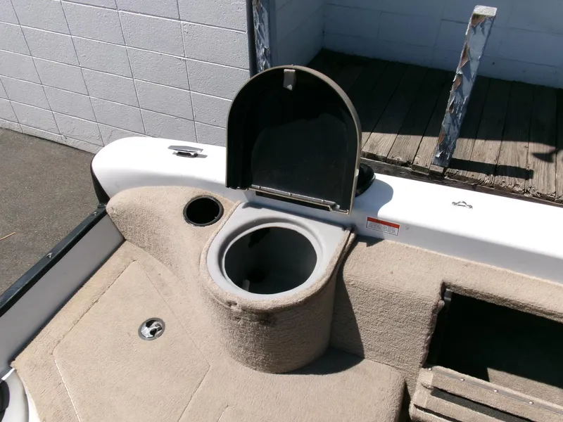 Slide: The Image of 2005 Tracker Tundra 18 DC boat interior with open storage compartment. - 24