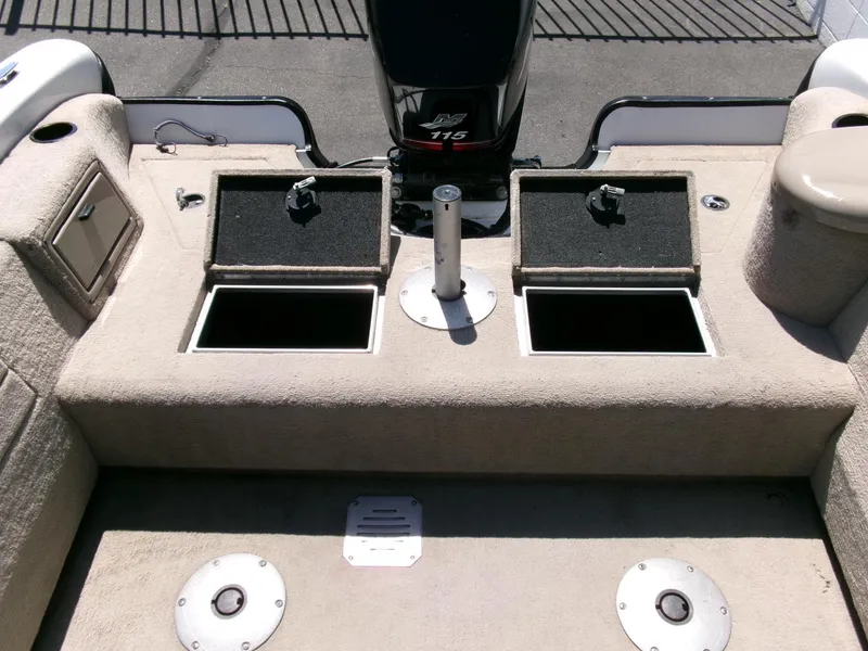 Slide: The Image of 2005 Tracker Tundra 18 DC boat interior with storage compartments and motor. - 26