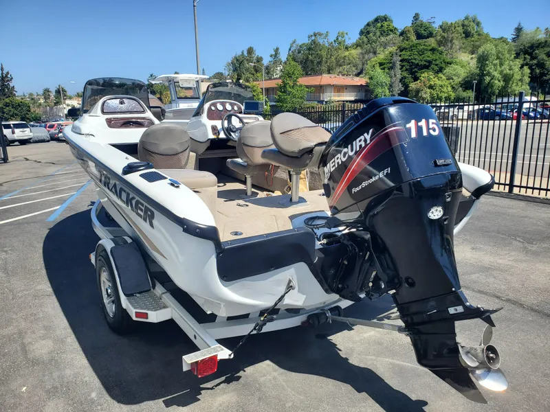 Slide: The Image of 2005 Tracker Tundra 18 DC boat with Mercury 115 outboard engine in a parking lot. - 3