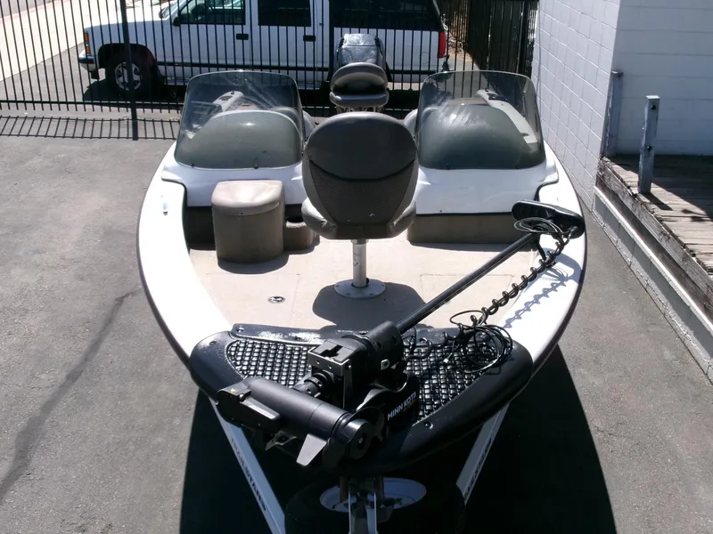 Slide: The Image of 2005 Tracker Tundra 18 DC boat with seating and trolling motor, parked outdoors. - 31