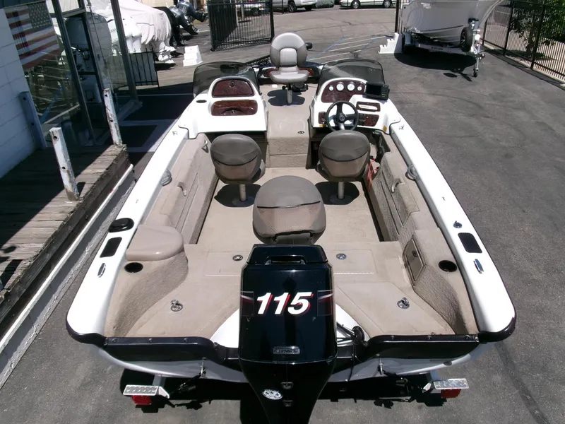 Slide: The Image of 2005 Tracker Tundra 18 DC fishing boat with seating and motor, parked outdoors. - 32