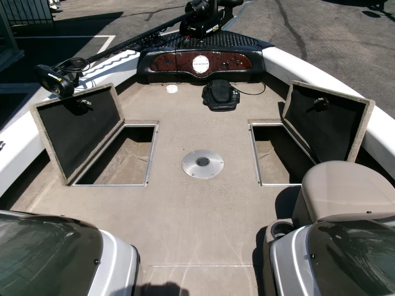 Slide: The Image of 2005 Tracker Tundra 18 DC boat interior with open storage compartments. - 7