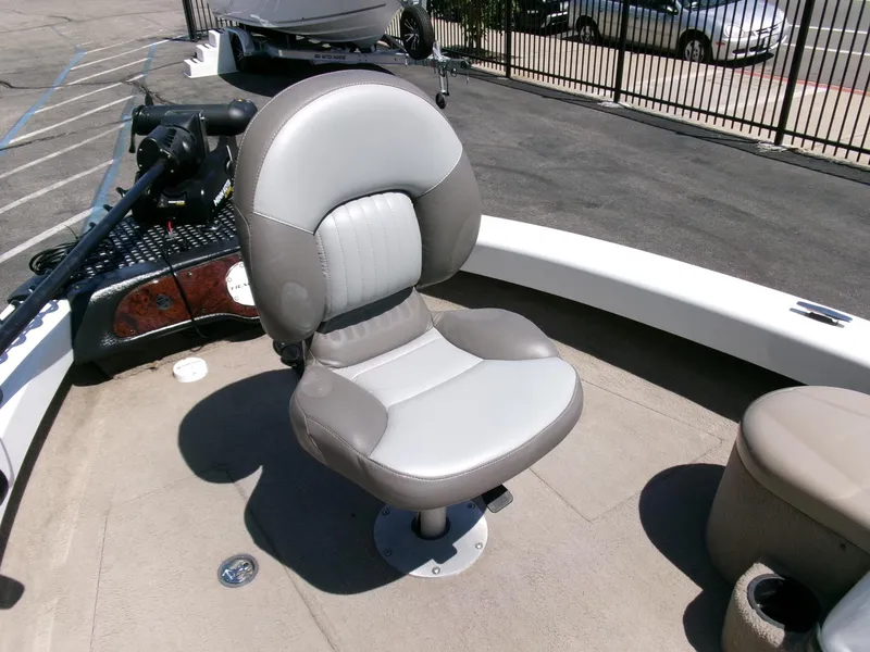 Slide: The Image of 2005 Tracker Tundra 18 DC boat seat, gray and white, on deck. - 9