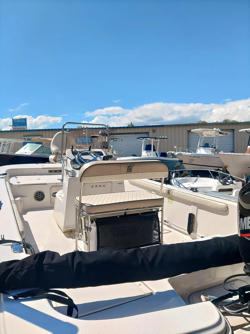 Slide: The Image of 2022 Carolina Skiff 19 LS boat in a marina under a clear blue sky. - 2