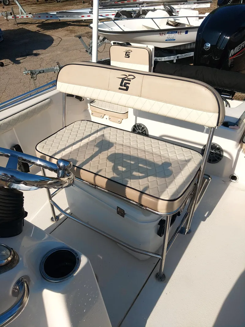 Slide: The Image of 2022 Carolina Skiff 19 LS boat interior with cushioned seating and steering wheel. - 3