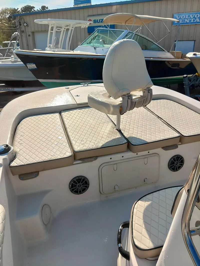 Slide: The Image of 2022 Carolina Skiff 19 LS boat interior with cushioned seating and storage compartments. - 6