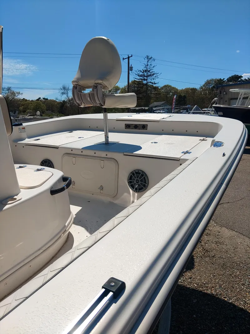 Slide: The Image of 2022 Carolina Skiff 19 LS boat with seating and storage, under clear blue sky. - 7