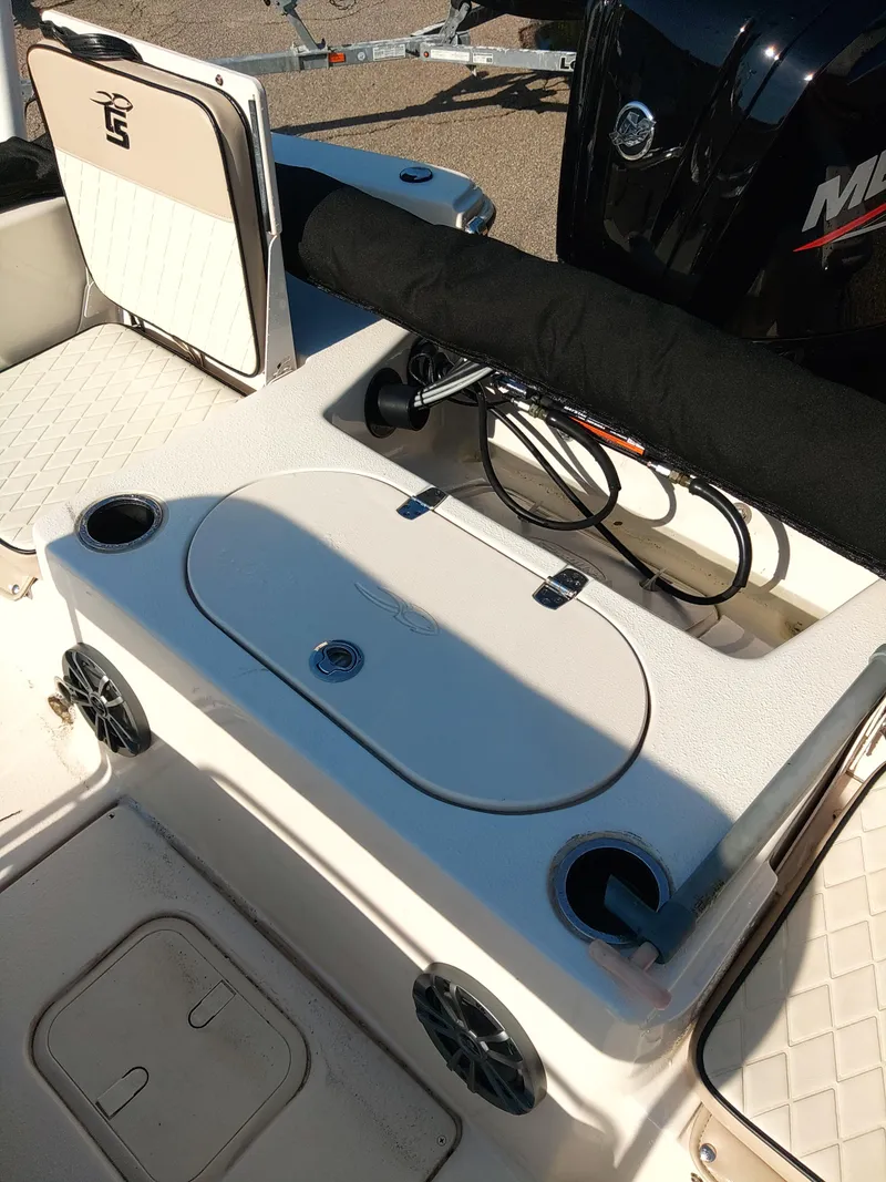 Slide: The Image of 2022 Carolina Skiff 19 LS boat interior with storage compartments and speakers. - 9