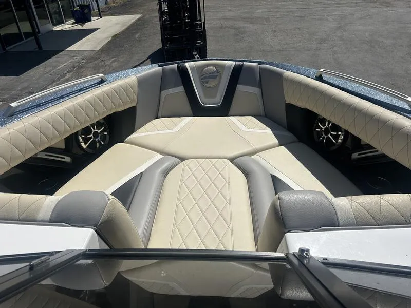 Slide: The Image of 2019 Tigé ZX5 boat interior with beige and gray diamond-stitched seating. - 4