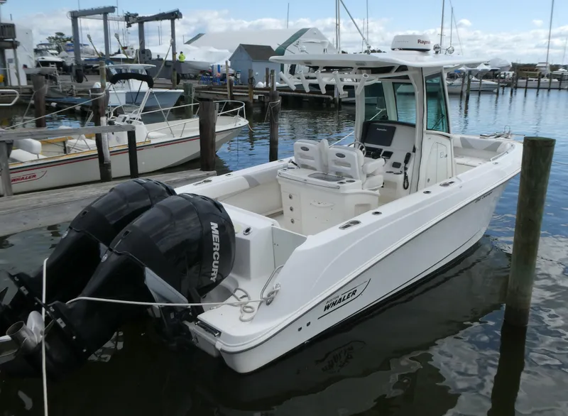 Slide: The Image of 2016 Boston Whaler 250 Outrage boat docked with twin Mercury engines. - 0