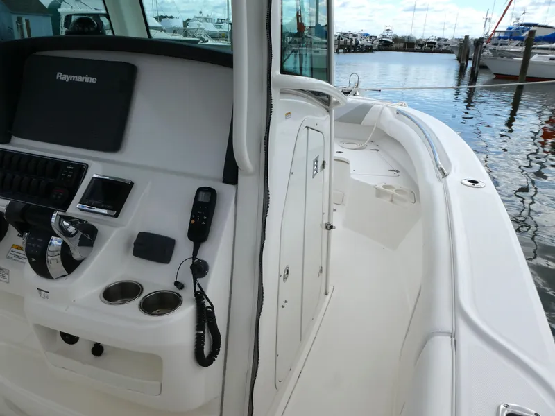 Slide: The Image of 2016 Boston Whaler 250 Outrage boat interior with control panel and Raymarine equipment. - 10