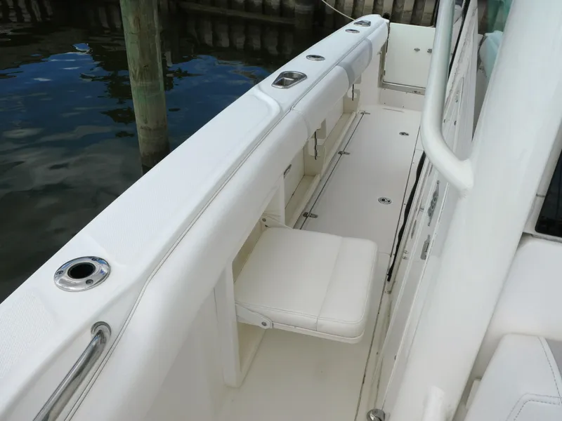 Slide: The Image of 2016 Boston Whaler 250 Outrage boat interior with seating and rod holders. - 11
