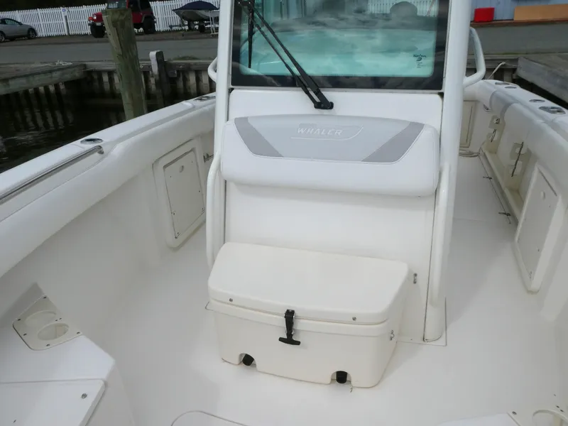 Slide: The Image of 2016 Boston Whaler 250 Outrage boat interior with seating and storage compartments. - 15