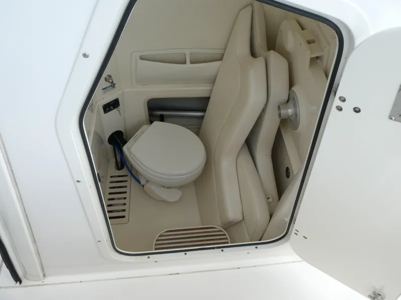 Slide: The Image of Interior of 2016 Boston Whaler 250 Outrage boat, featuring compact marine toilet. - 16
