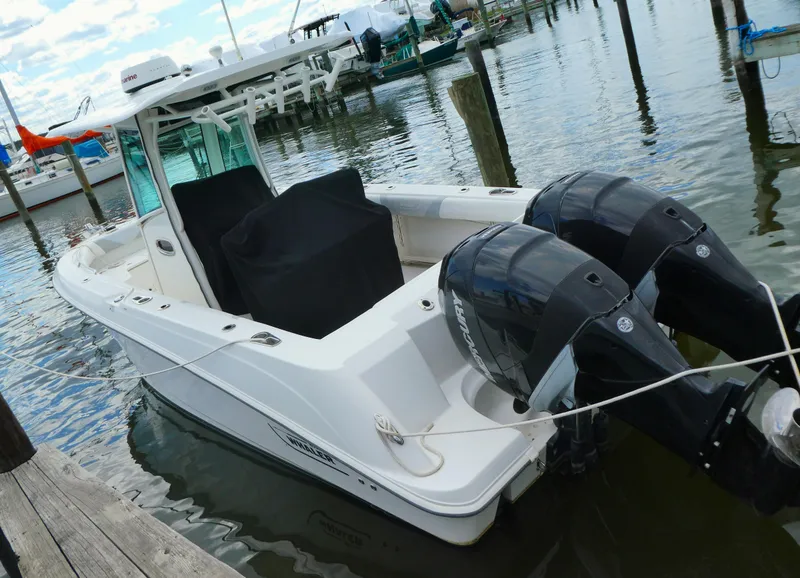 Slide: The Image of 2016 Boston Whaler 250 Outrage boat docked with dual outboard engines. - 2