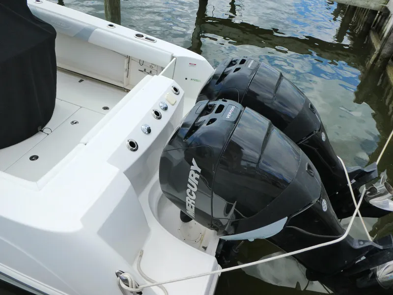 Slide: The Image of Boston Whaler 250 Outrage 2016 with dual Mercury outboard engines docked on water. - 4