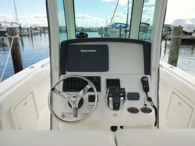 Slide: The Image of 2016 Boston Whaler 250 Outrage helm with Raymarine electronics, docked at marina. - 5