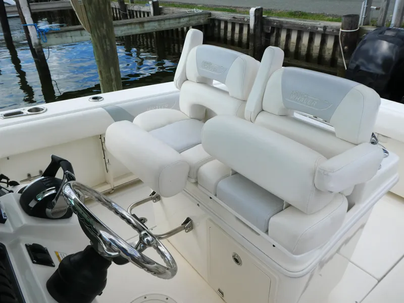 Slide: The Image of Boston Whaler 250 Outrage 2016 boat interior with dual white cushioned seats. - 6