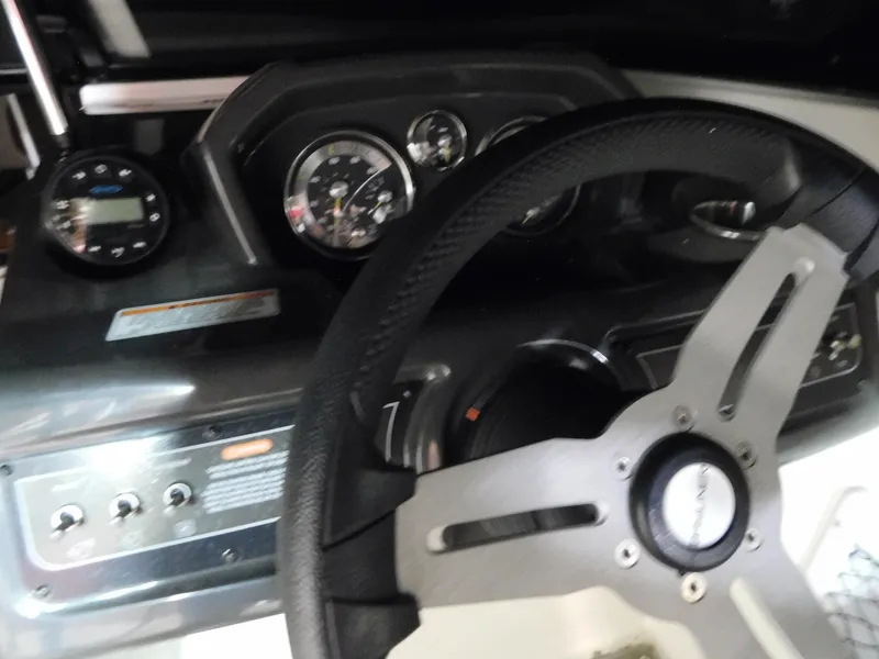 Slide: The Image of Dashboard of a 2020 Bayliner VR 6 boat with steering wheel and gauges. - 10