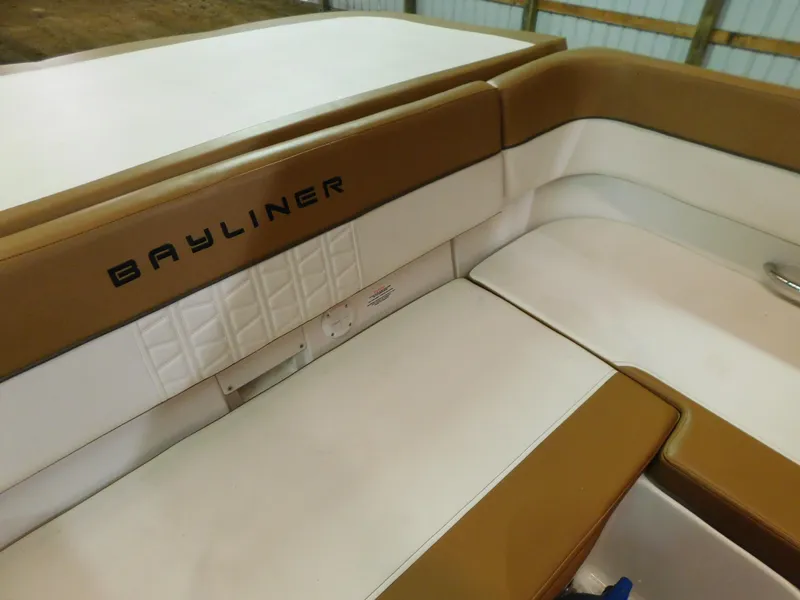 Slide: The Image of 2020 Bayliner VR 6 boat interior with tan and white seating. - 5
