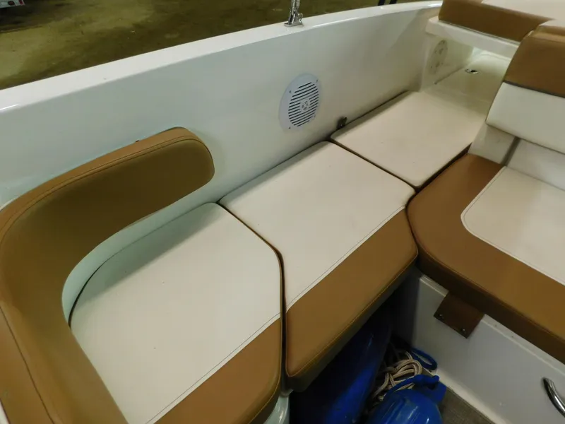 Slide: The Image of 2020 Bayliner VR 6 boat interior with tan and white cushioned seating. - 7