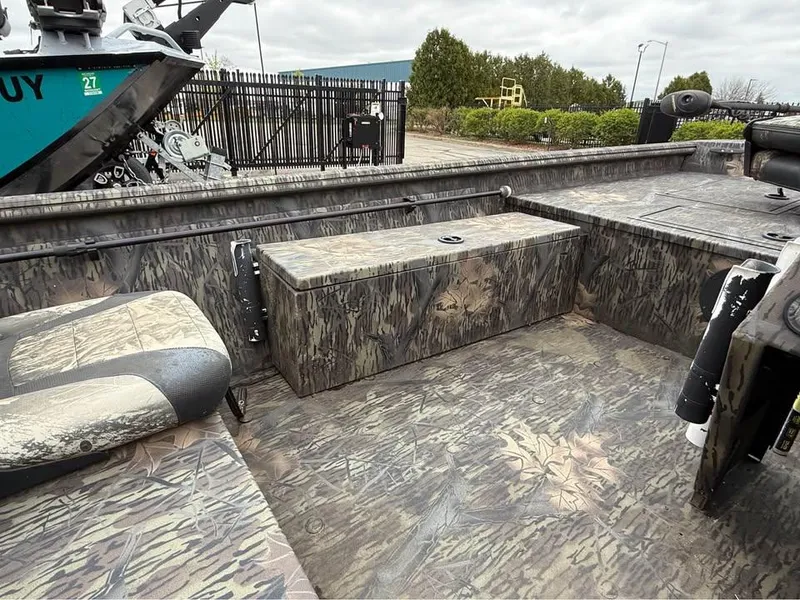 Slide: The Image of 2018 Lowe Roughneck 1760SC boat interior with camouflage design and seating. - 4